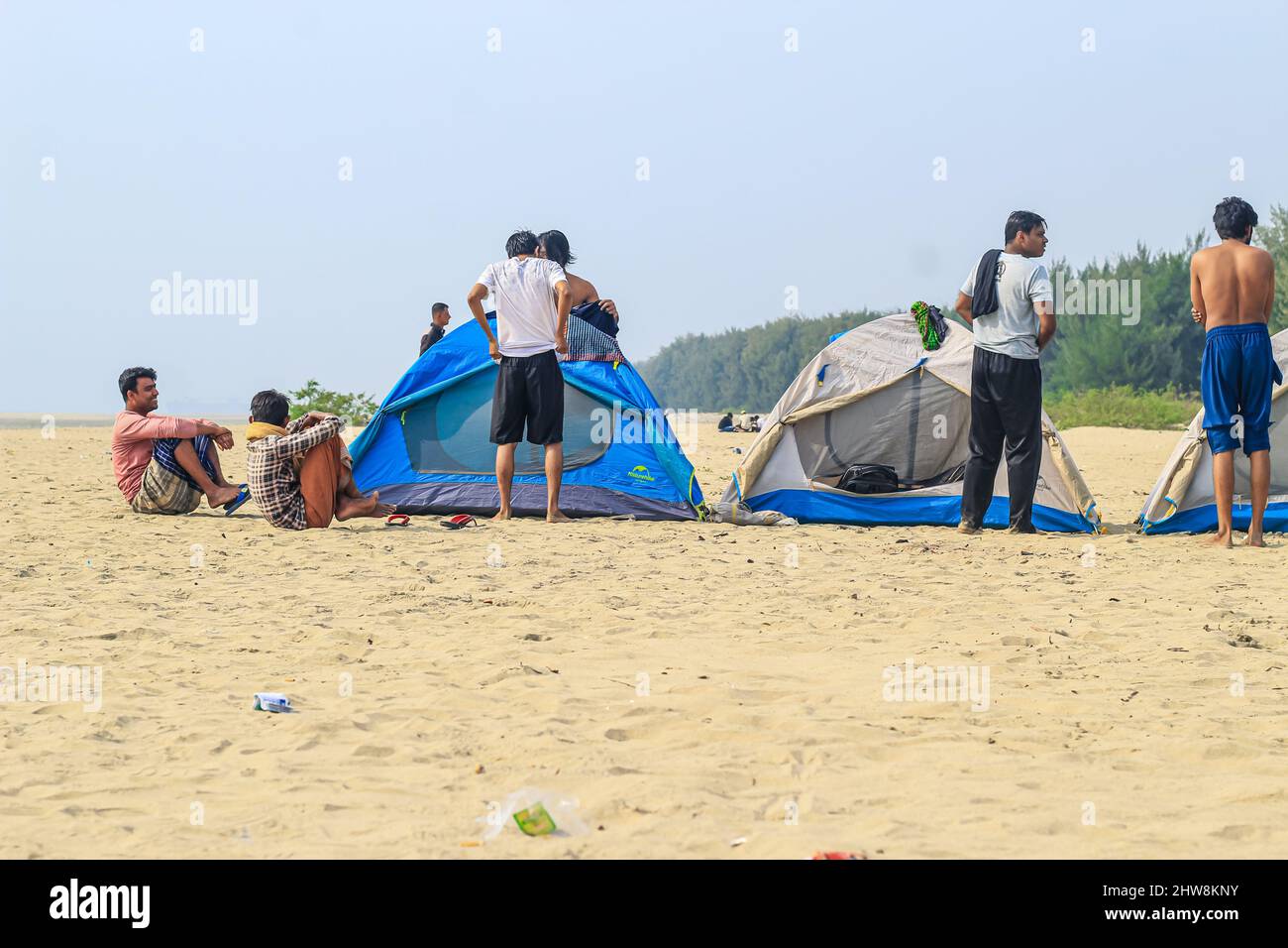 Campsite on the beach. Tents on a sea beach with sky and green