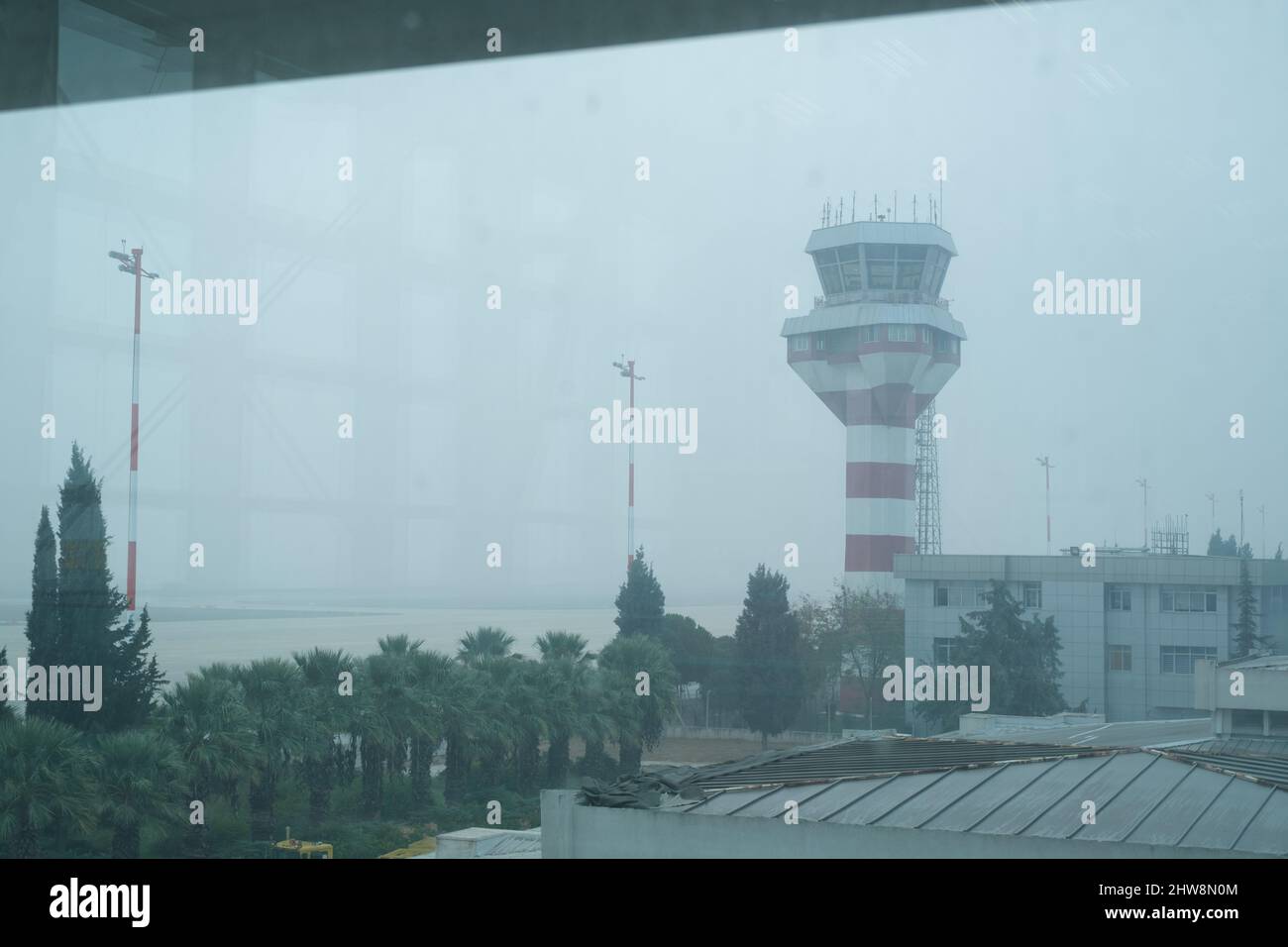 Izmir, Turkey - November 9, 2021: Airport control tower at Izmir Adnan Menderes Airport in a foggy weather. Editorial shot in Izmir Turkey. Stock Photo