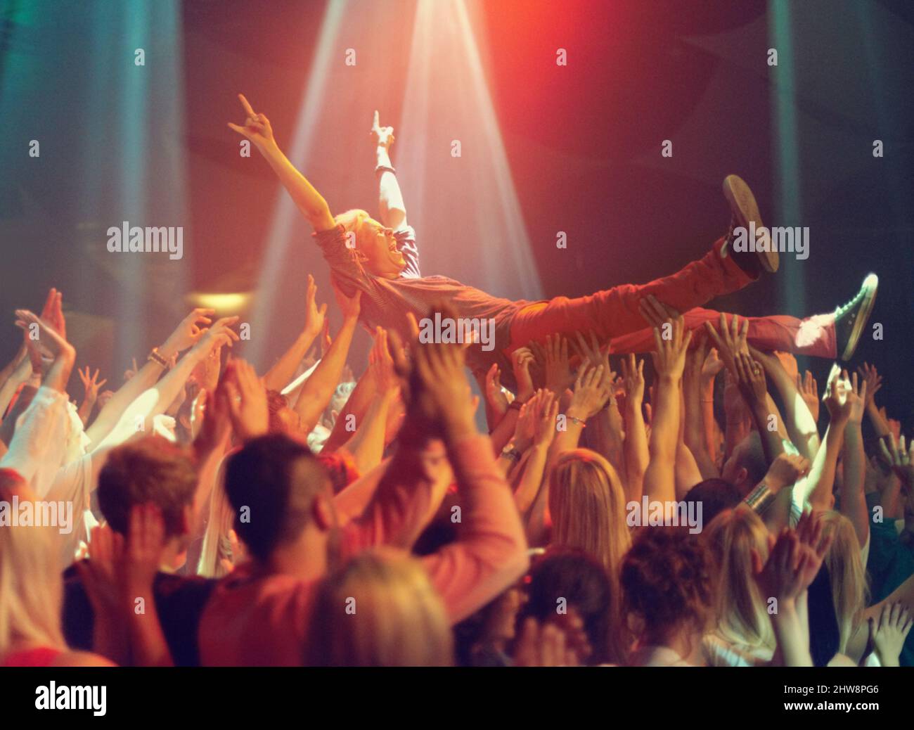 A young man crowd surfing to his favorite band. This concert was created for the sole purpose of this photo shoot, featuring 300 models and 3 live Stock Photo