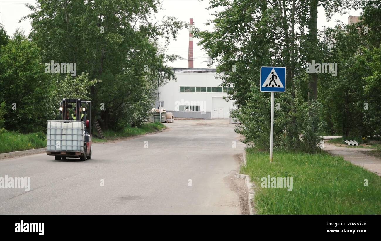 Forklift loading and moving material down from a factory. Clip. Loading ...