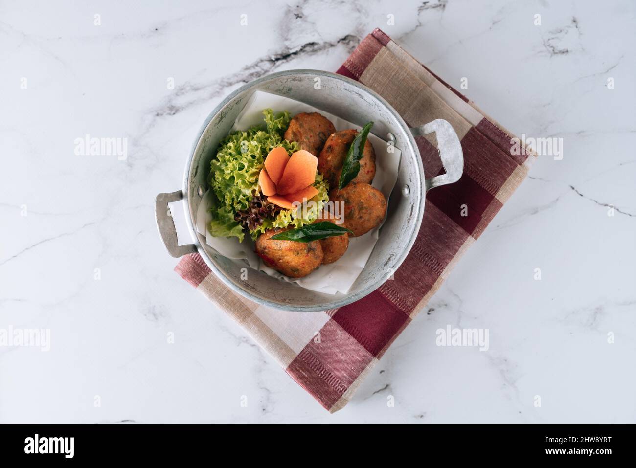Fried Fish Cake cod fish patties in a dish isolated on mat top view on grey marble background Stock Photo
