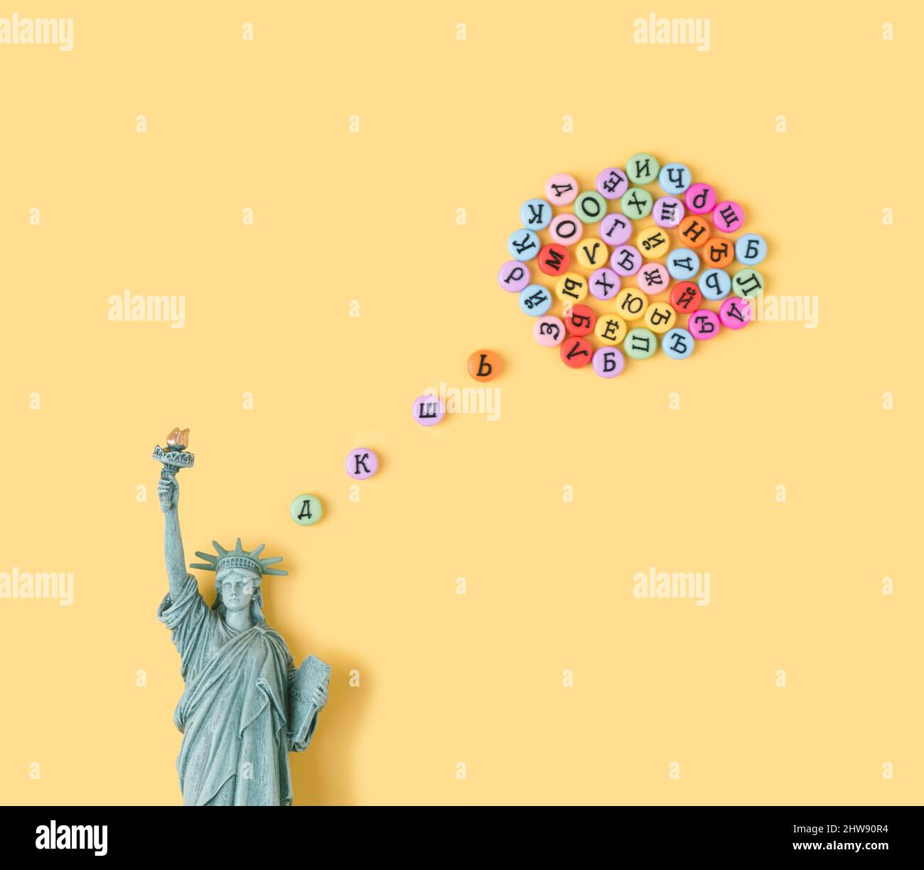 Statue of Liberty with thinking bubble made of cyrillic letters. USA, Russia politics conceptual background. Stock Photo