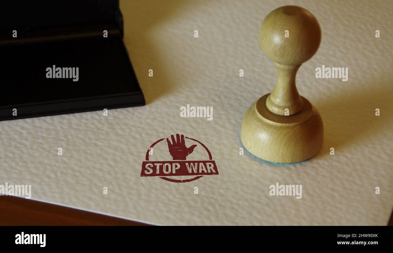 Stop war stamp and stamping hand. Peace, no aggression and pacifism concept. Stock Photo