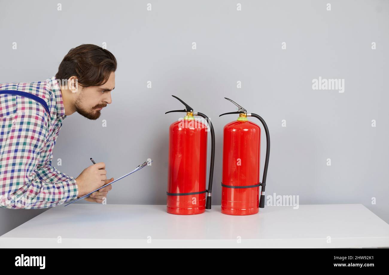 Fire safety engineer with clipboard checking condition of fire