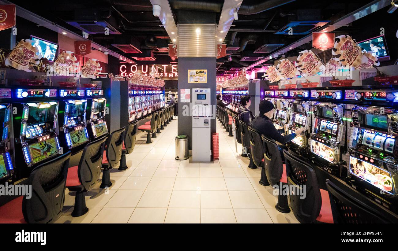TOKYO - MARCH 27, 2017: Two rows of japanese slot machines in the unidentified game center in Tokyo, Japan Stock Photo