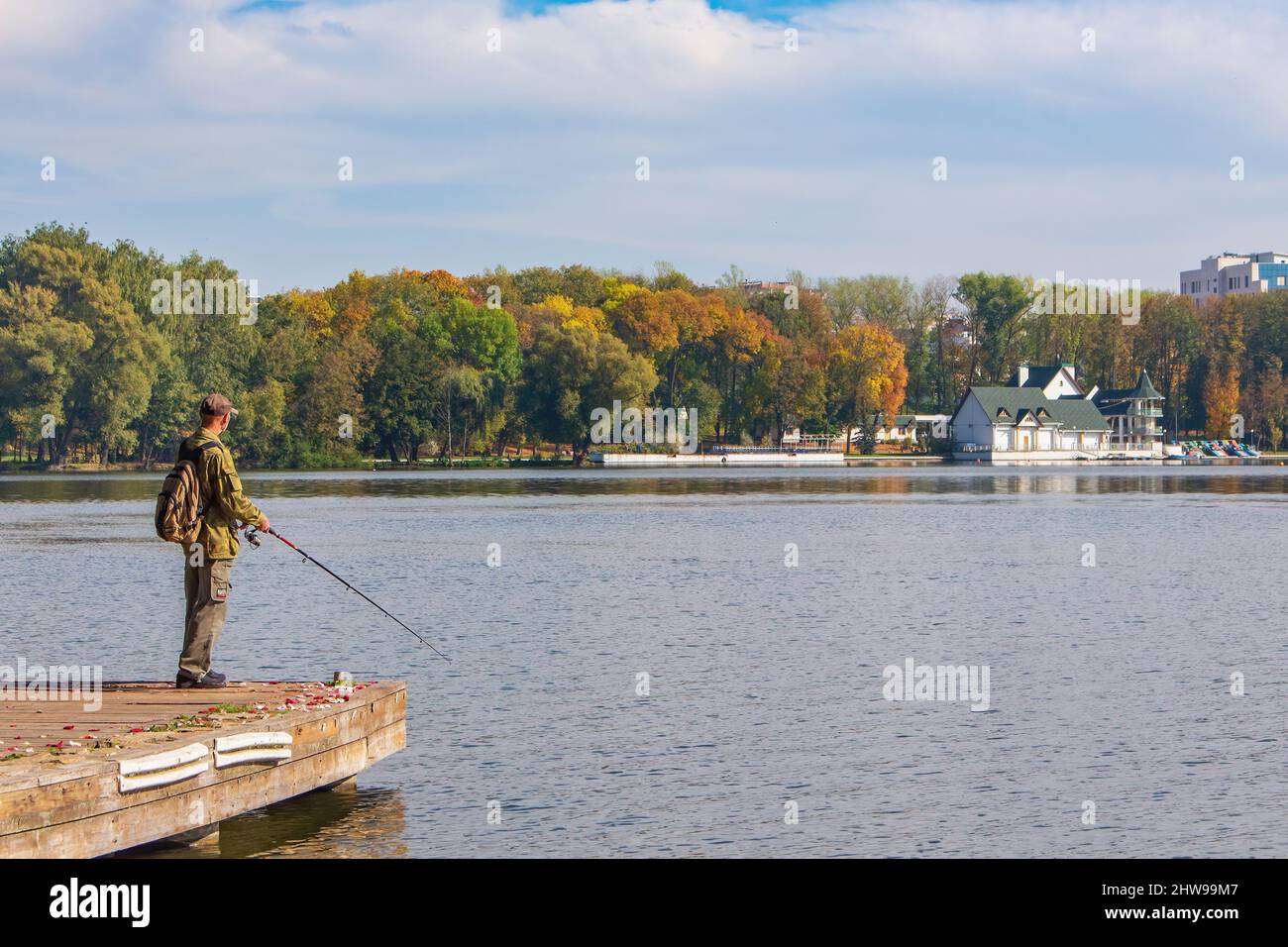 MINSK, BELARUS - October 04, 2015: Fishing in the city. An elderly man with a spinning rod Stock Photo