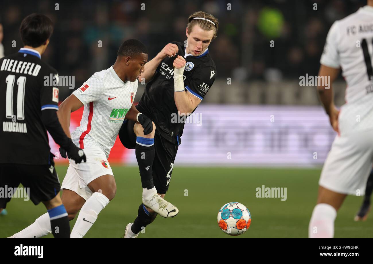 Bielefeld, Germany. 04th Mar, 2022. Soccer: Bundesliga, Arminia Bielefeld - FC Augsburg, Matchday 25 at Schüco Arena. Bielefeld's Patrick Wimmer (r) battles for the ball with Augsburg's Carlos Gruezo (2nd from left). Credit: Friso Gentsch/dpa - IMPORTANT NOTE: In accordance with the requirements of the DFL Deutsche Fußball Liga and the DFB Deutscher Fußball-Bund, it is prohibited to use or have used photographs taken in the stadium and/or of the match in the form of sequence pictures and/or video-like photo series./dpa/Alamy Live News Stock Photo