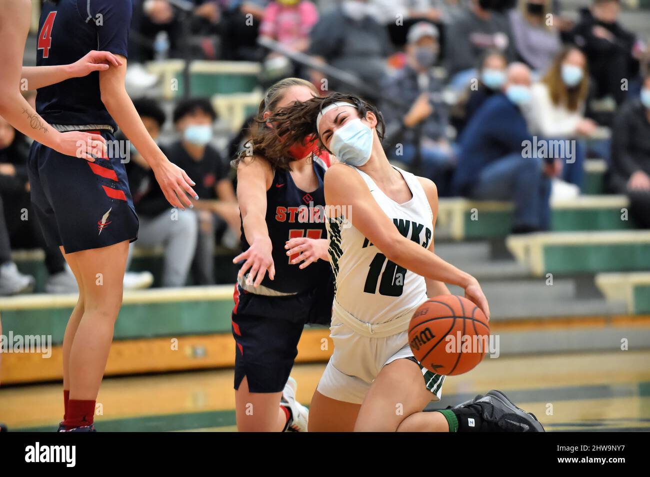 USA. Player trying to control the ball and assume control during a scramble for the basketball that took two players to the floor. Stock Photo