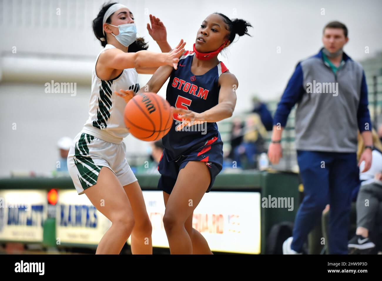USA. A player, left, closely defending an opponent as she attempted to gain control the basketball. Stock Photo