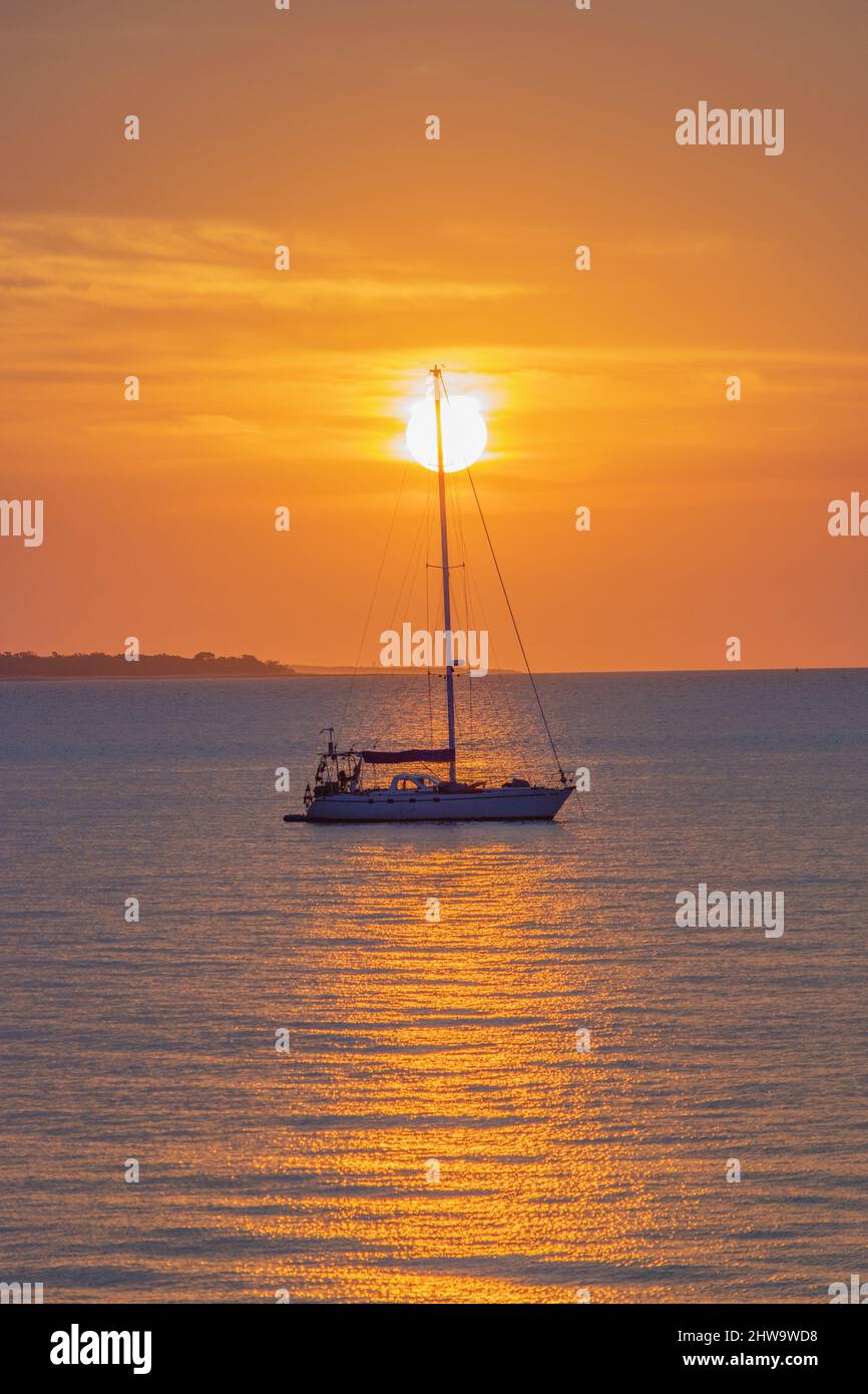 Vertical photo of a boat in the sea at sunset Stock Photo - Alamy
