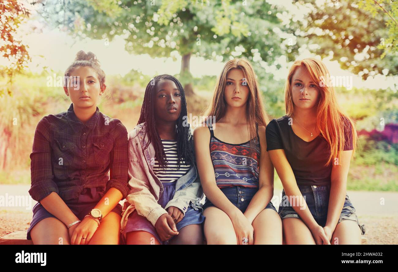 They were the generation of independence and attitude. Four young girls looking at the camera with a serious expression. Stock Photo
