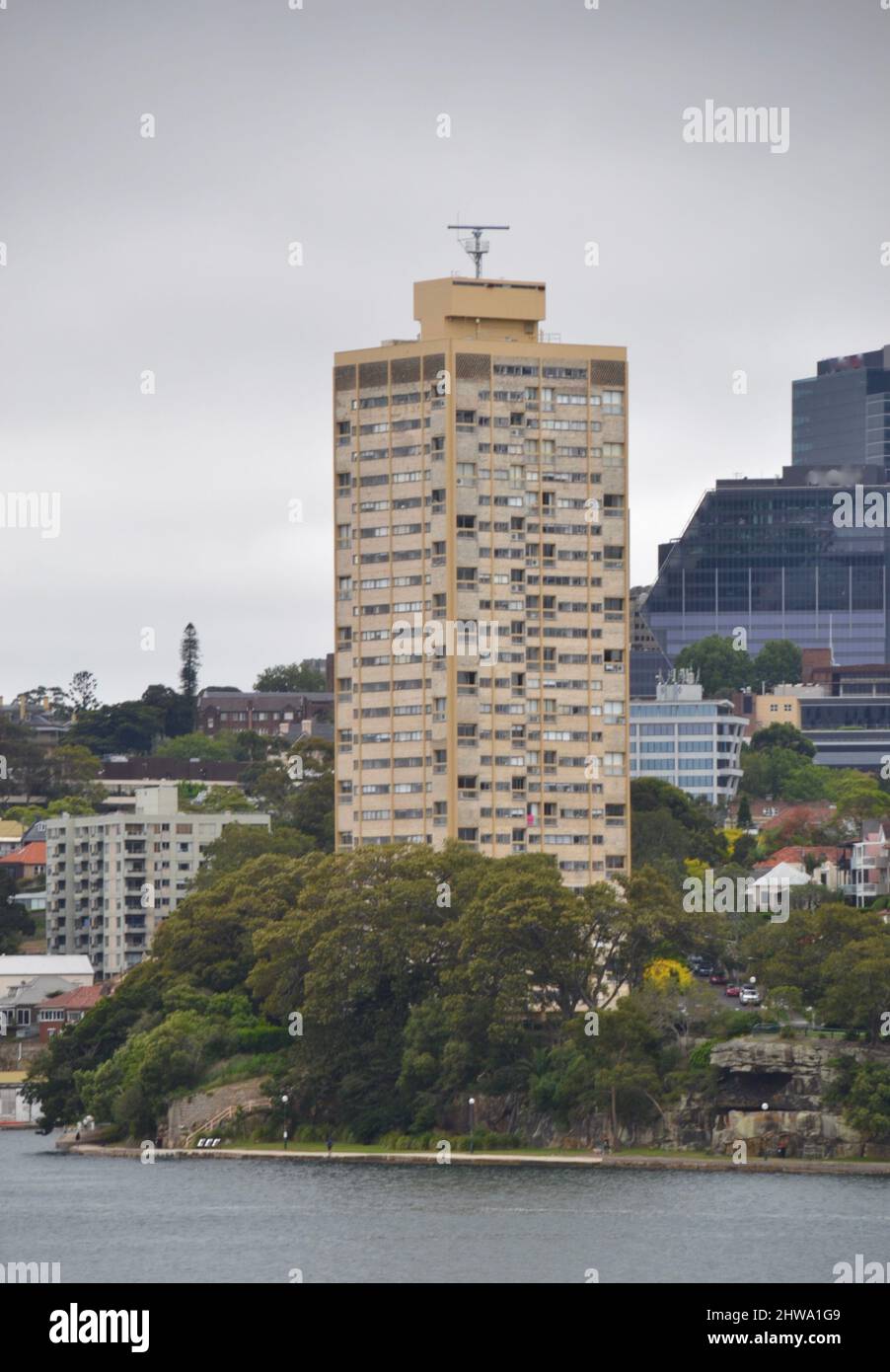 Controversial and divisive architecture of Harry Seidler's Blues Point Tower apartment building in North Sydney sits right on the harbour Stock Photo