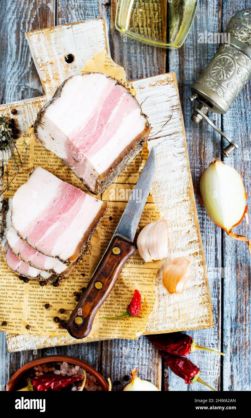 Chunks of salted bacon on dark background. Healthy food with pranami