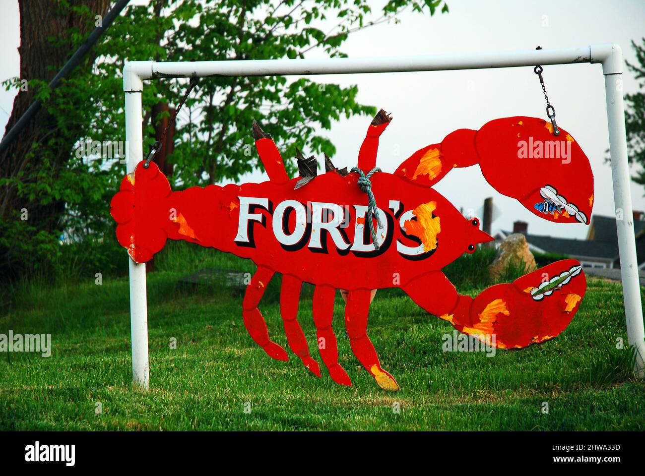 A weathered sign in Niantic, Connecticut tells folks that lobster is the specialty Stock Photo