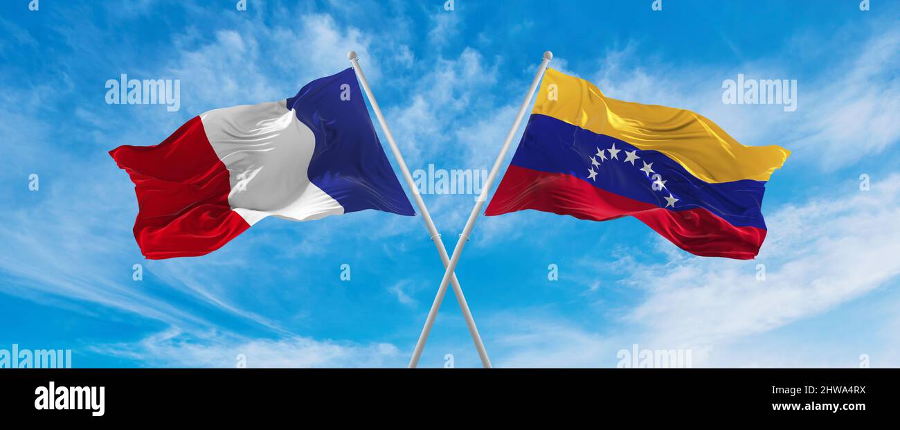 crossed national flags of France and Venezuela flag waving in the wind ...