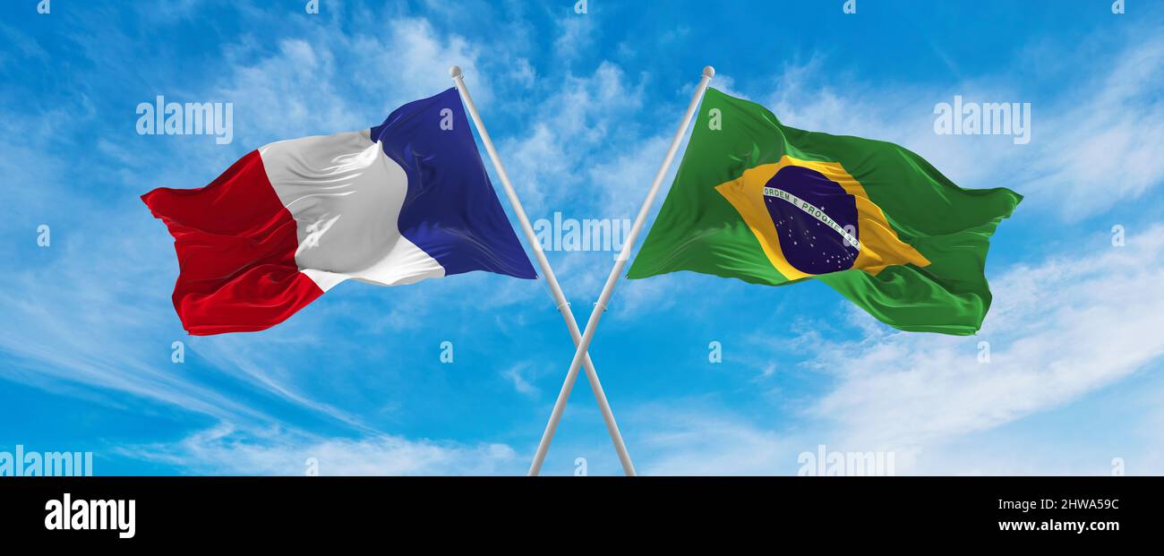 crossed national flags of France and Brazil flag waving in the wind at ...