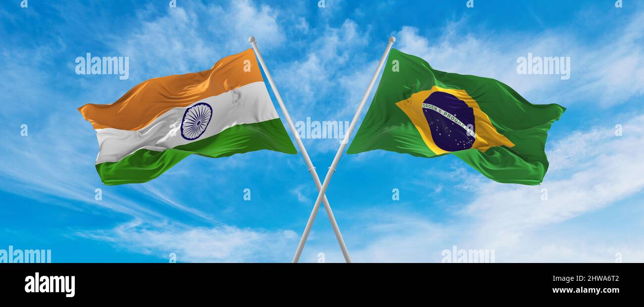crossed national flags of India and Brazil flag waving in the wind at ...