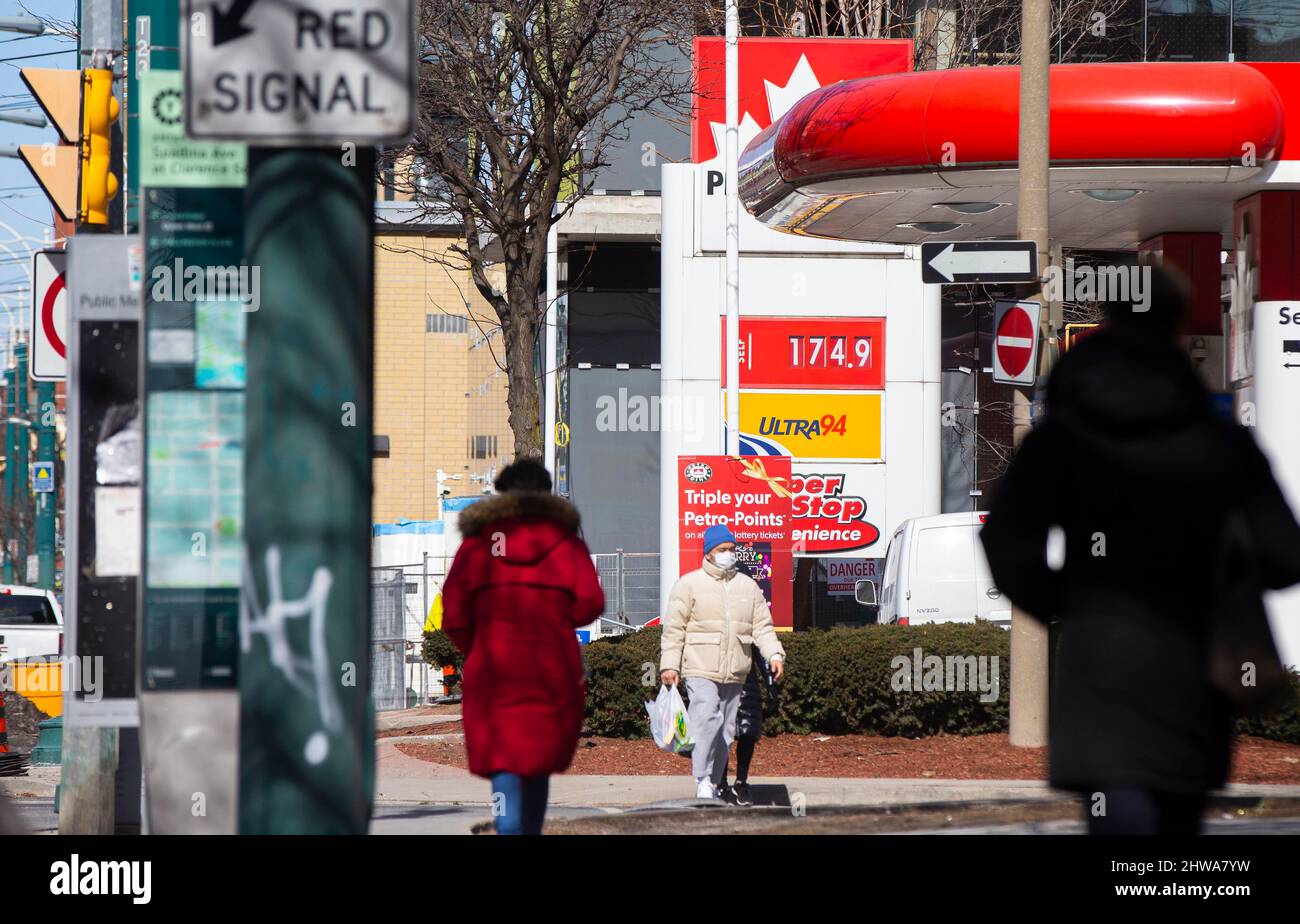 Toronto, Canada. 4th Mar, 2022. People walk past a gas station in