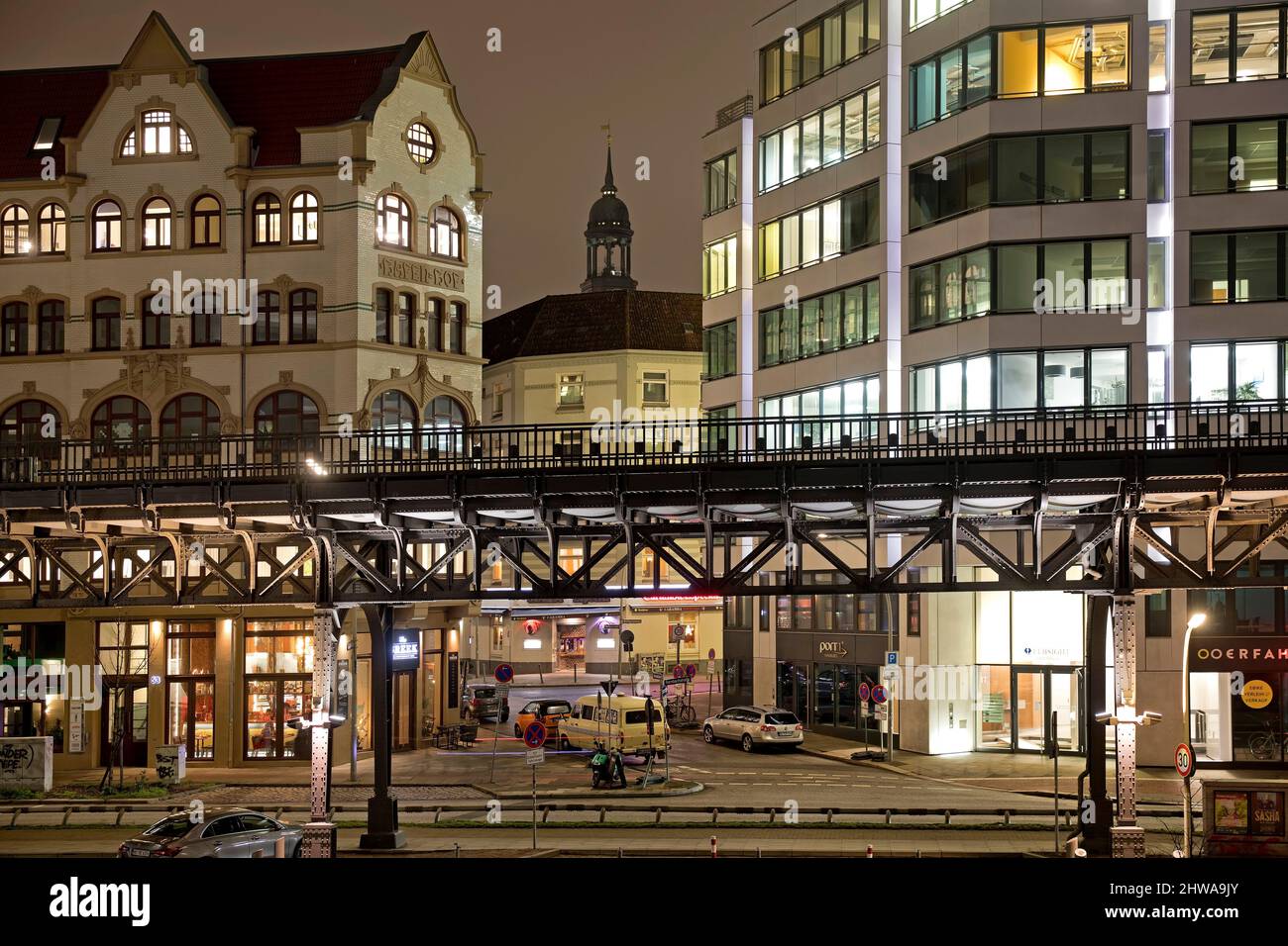 Railtrack of the elevated railway with steeple of the church St. Michaelis at night, Germany, Hamburg Stock Photo