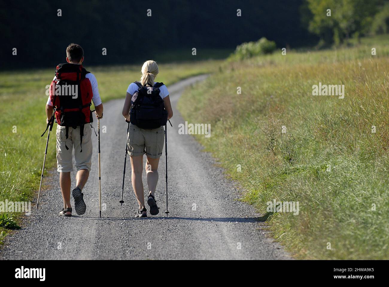 couple walking on field path, Germany Stock Photo