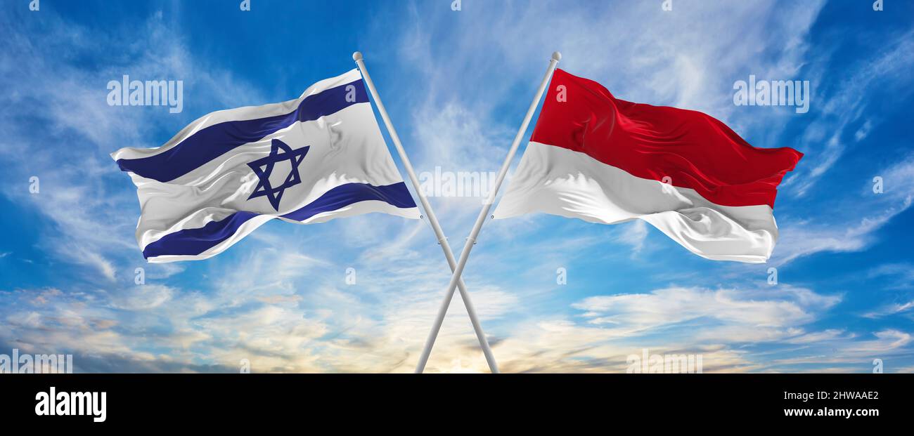 crossed national flags of Israel and Monaco flag waving in the wind at ...