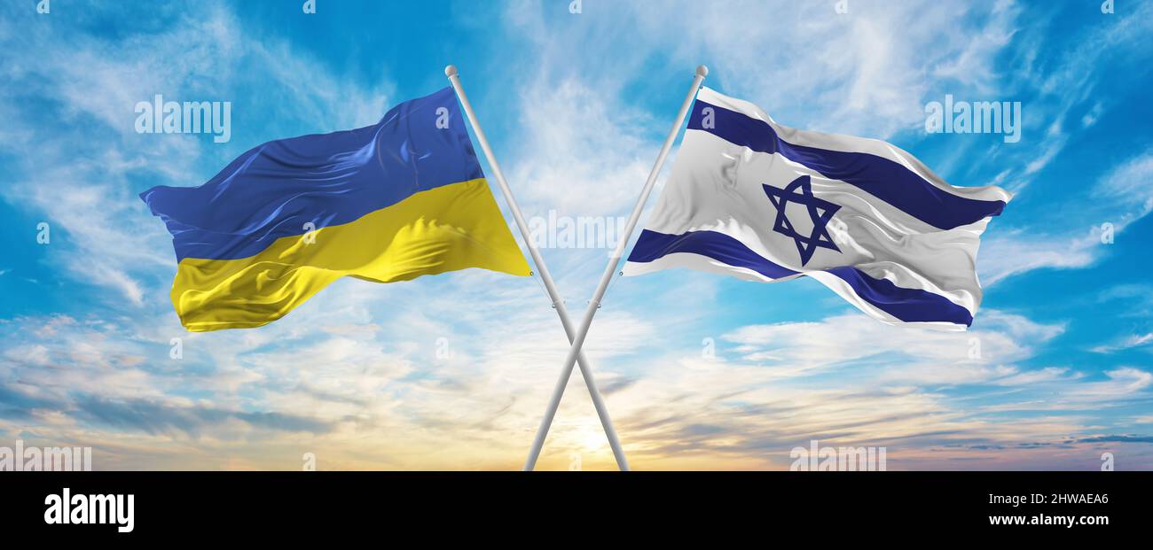 crossed national flags of Ukraine and Israel flag waving in wind at ...