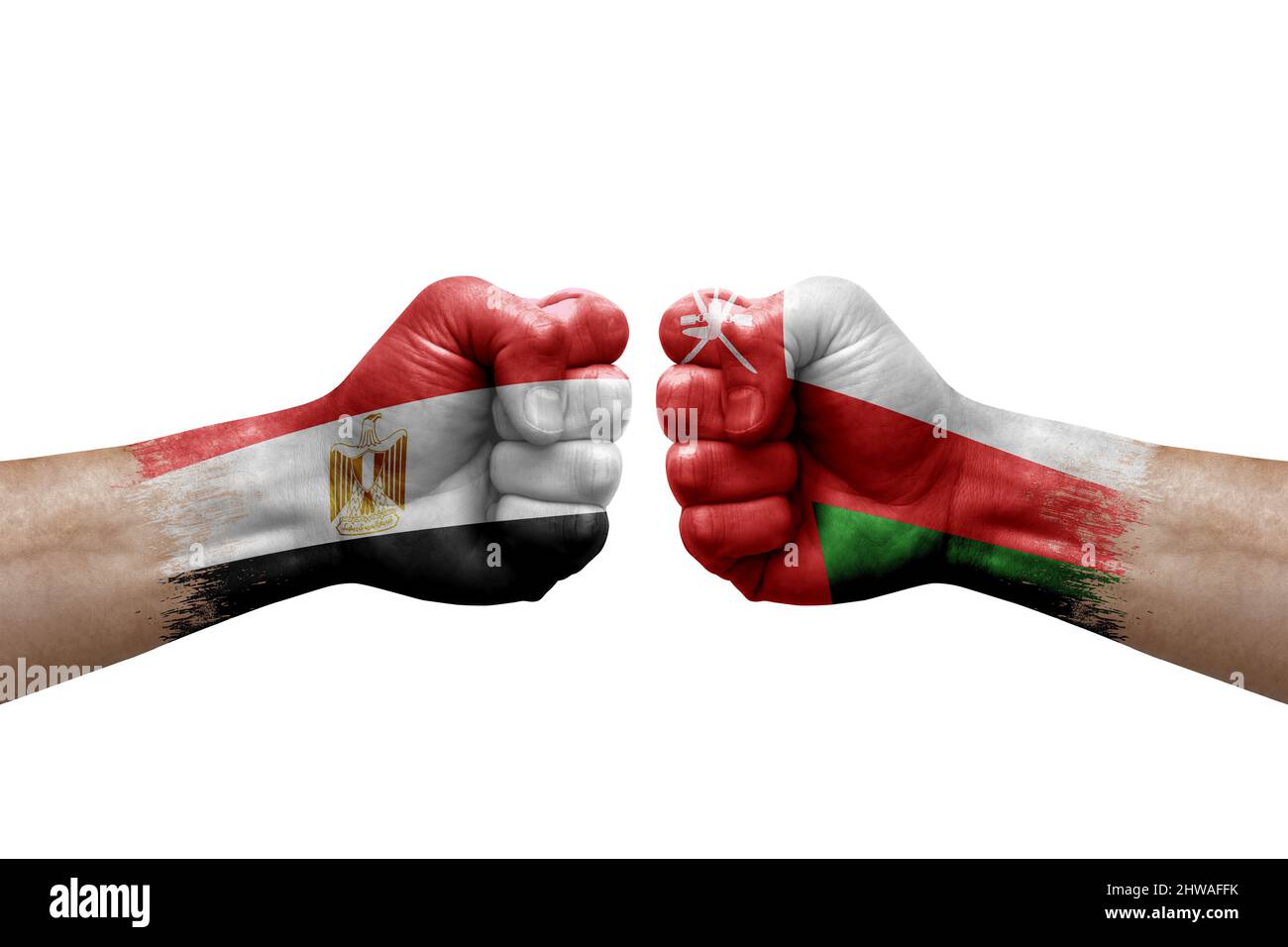 Two hands punch to each others on white background. Country flags painted fists, conflict crisis concept between egypt and oman Stock Photo