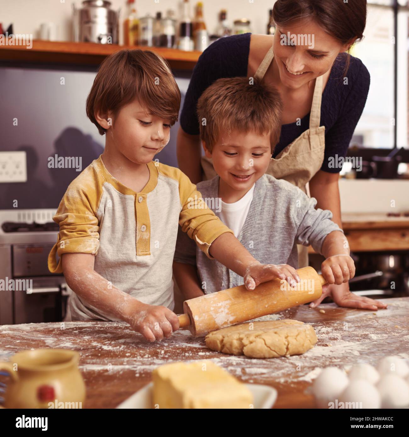 Messy but tasty. Cropped shot of two young brothers baking in the kitchen. Stock Photo