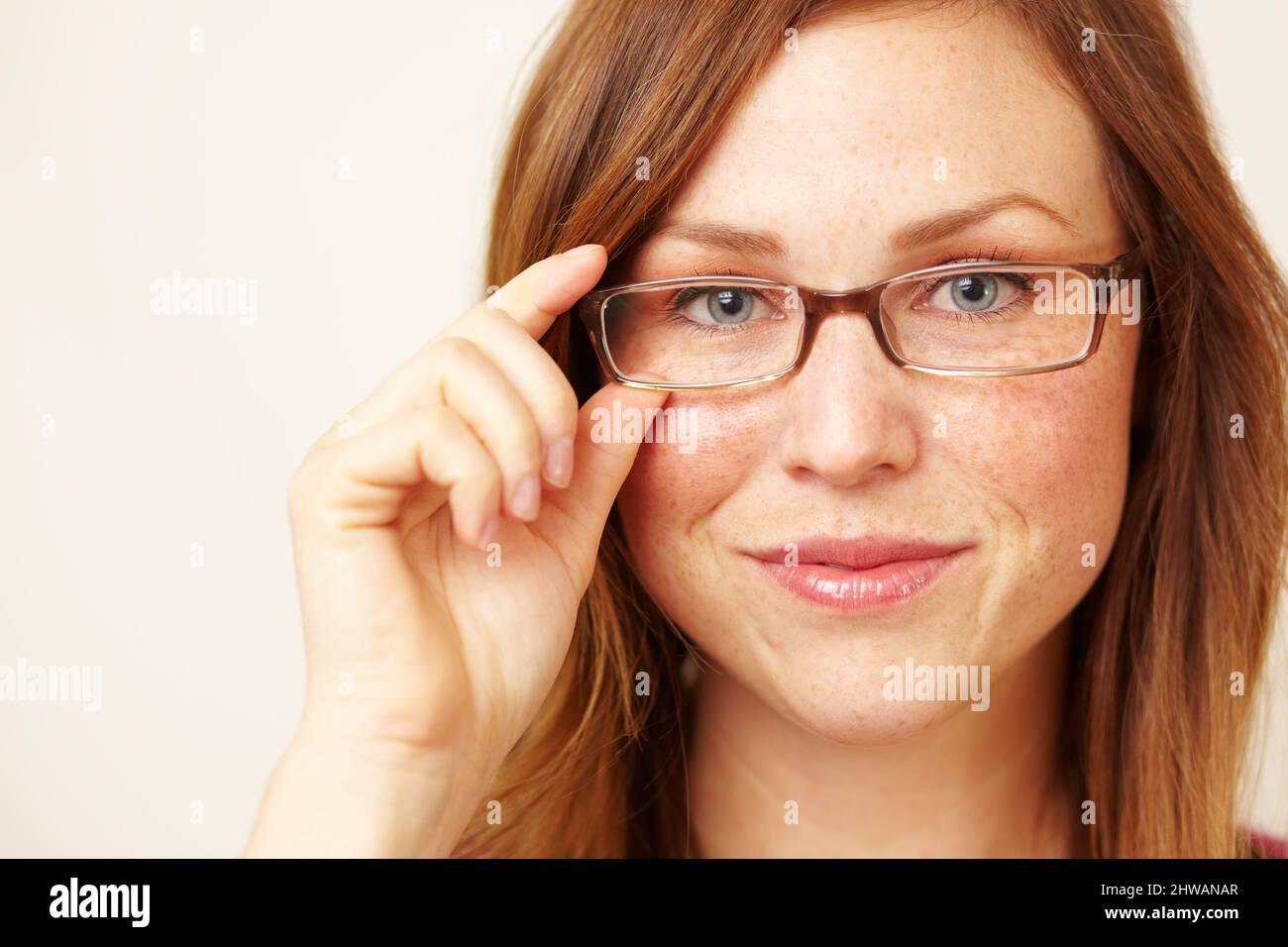 Shes one smart cookie. Cropped portrait of a beautiful young redhead