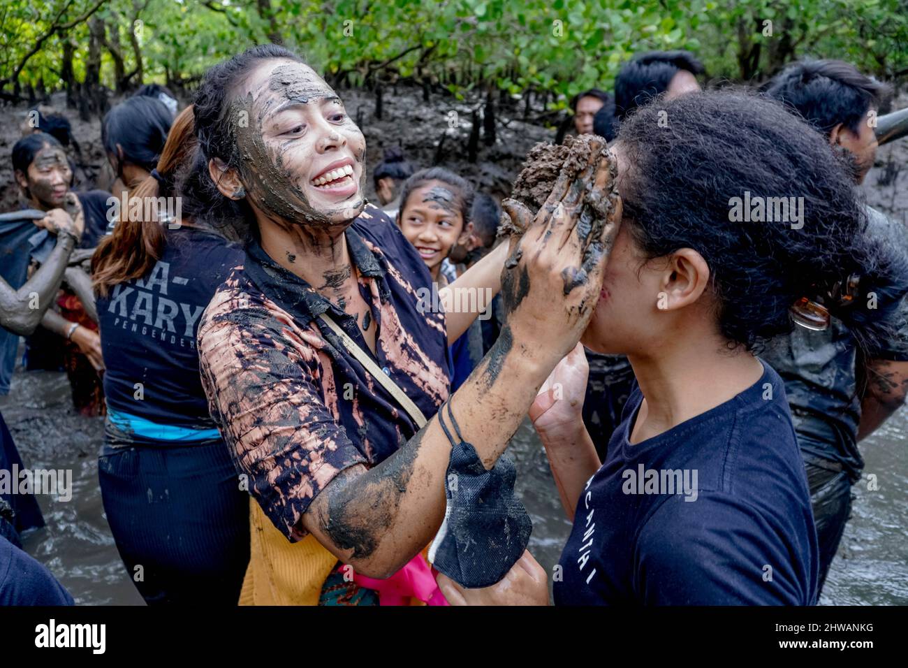 Bali, Indonesia. 4th Mar, 2022. A woman puts mud on her partner's face ...