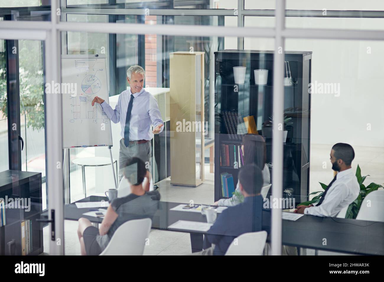 With your help, I think we can overcome this hurdle. Cropped shot of a businessman giving a presentation in the boardroom. Stock Photo