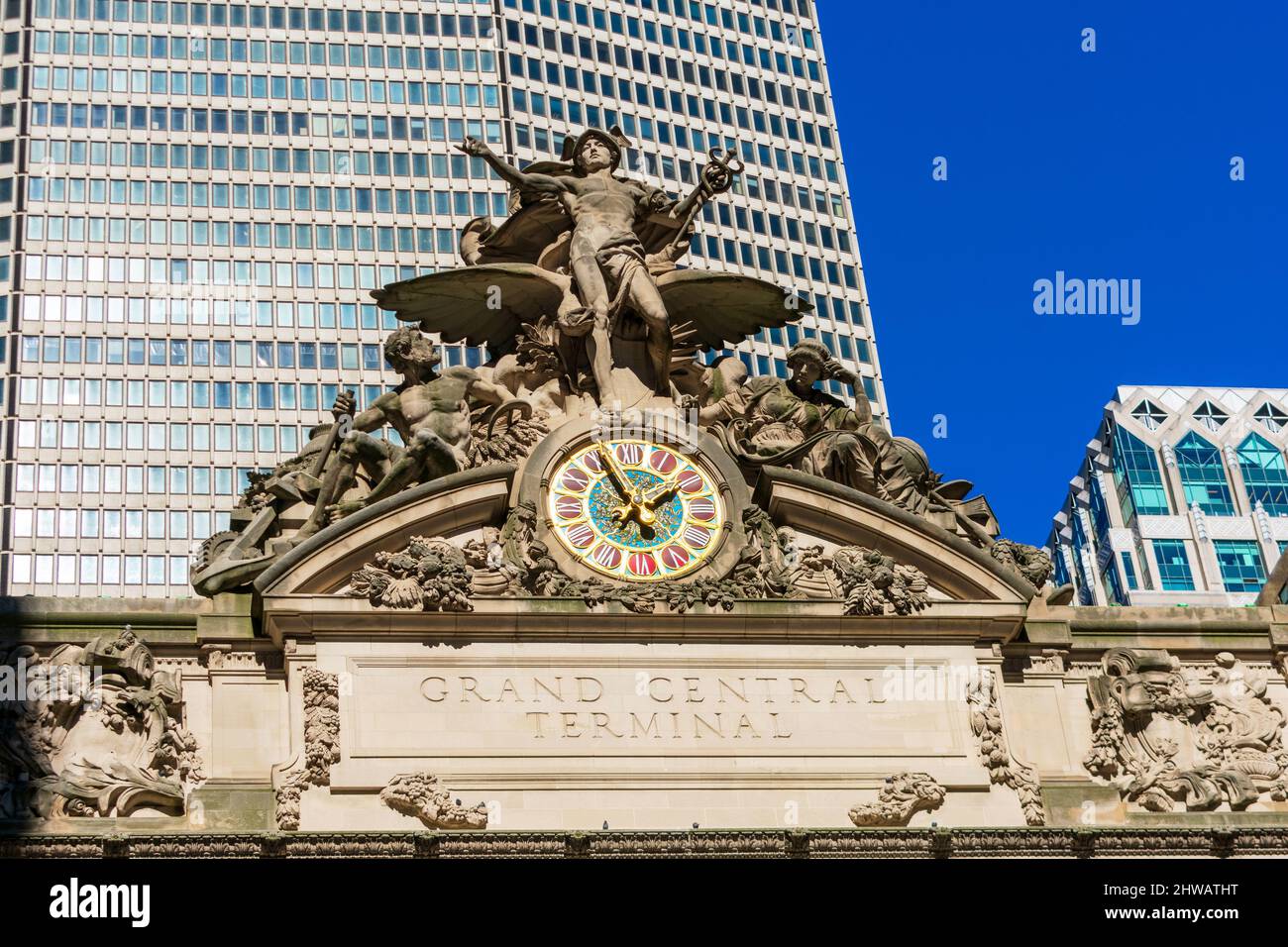 Grand Central Terminal sign, Glory of Commerce sculptural group above large clock atop the terminal facade - New York, USA, 2022 Stock Photo