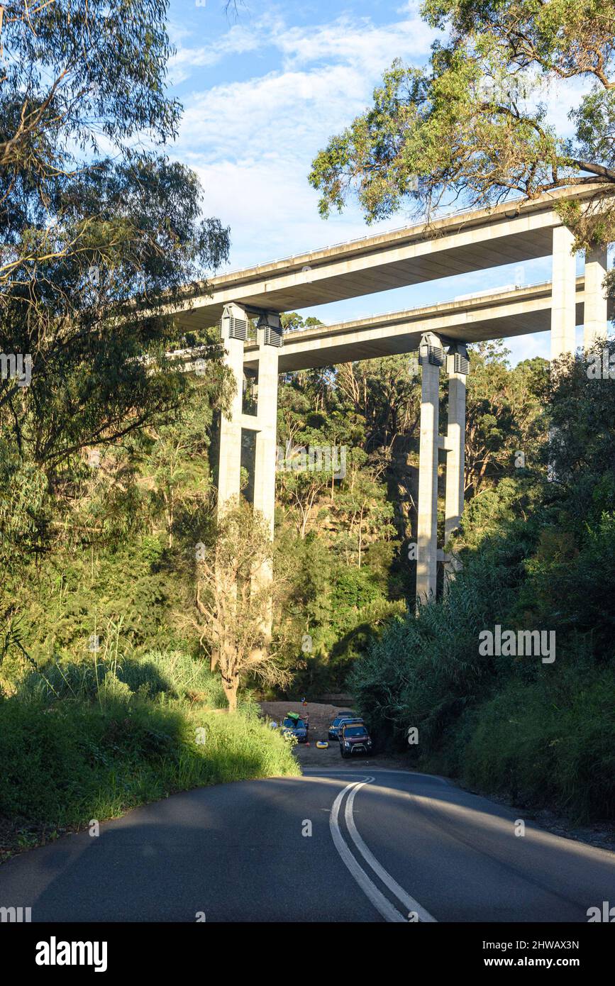 Cars parked below the M31 Hume Highway Douglas Park Bridge passing over the Nepean River at Douglas Park, New South Wales Stock Photo