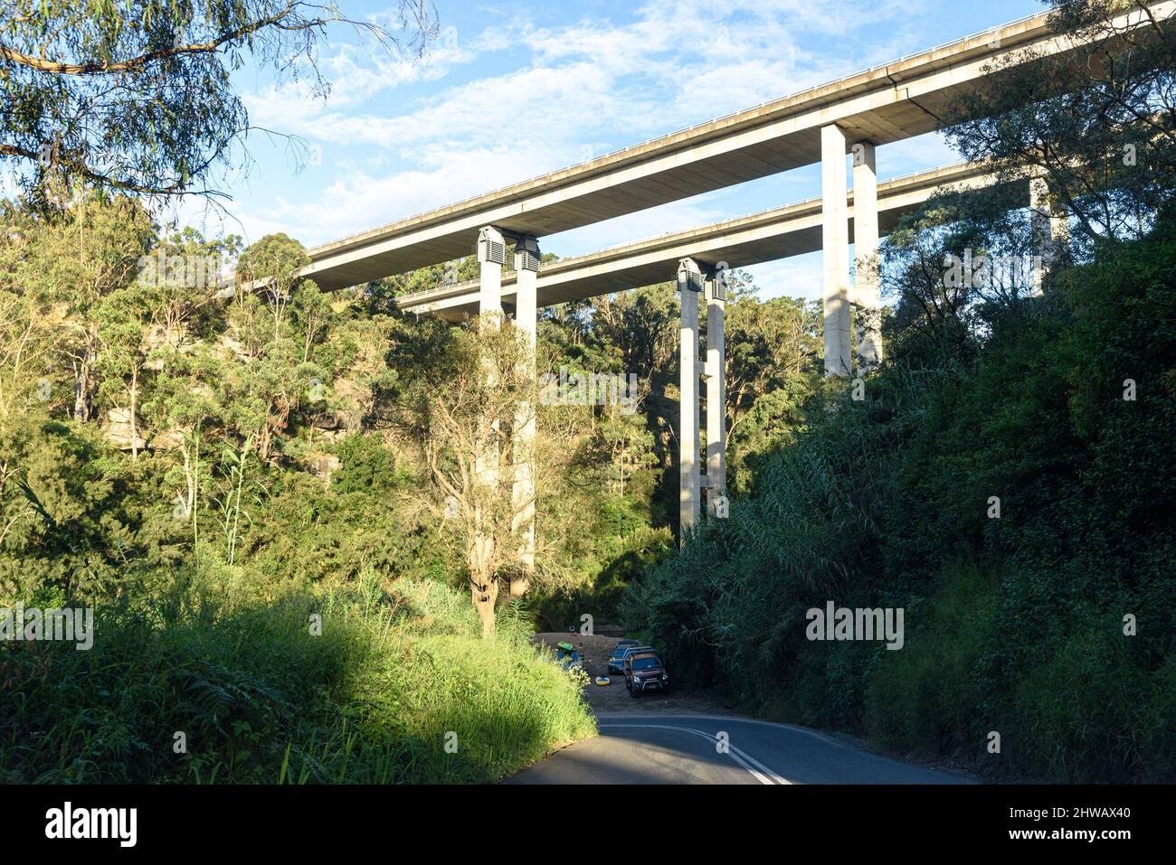 Cars parked below the M31 Hume Highway Douglas Park Bridge passing over the Nepean River at Douglas Park, New South Wales Stock Photo