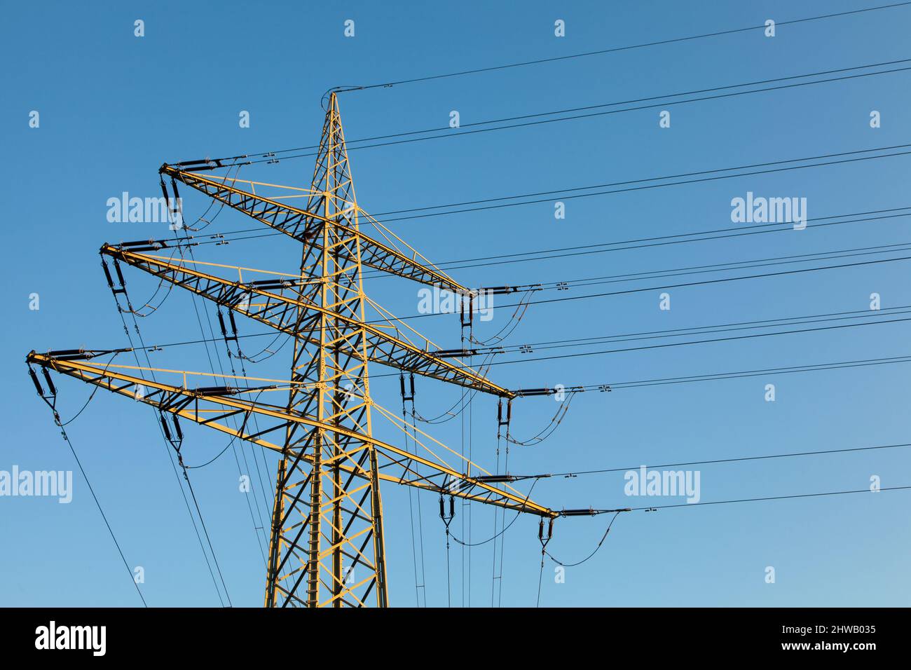 High voltage power pole industry clear blue sky Stock Photo - Alamy