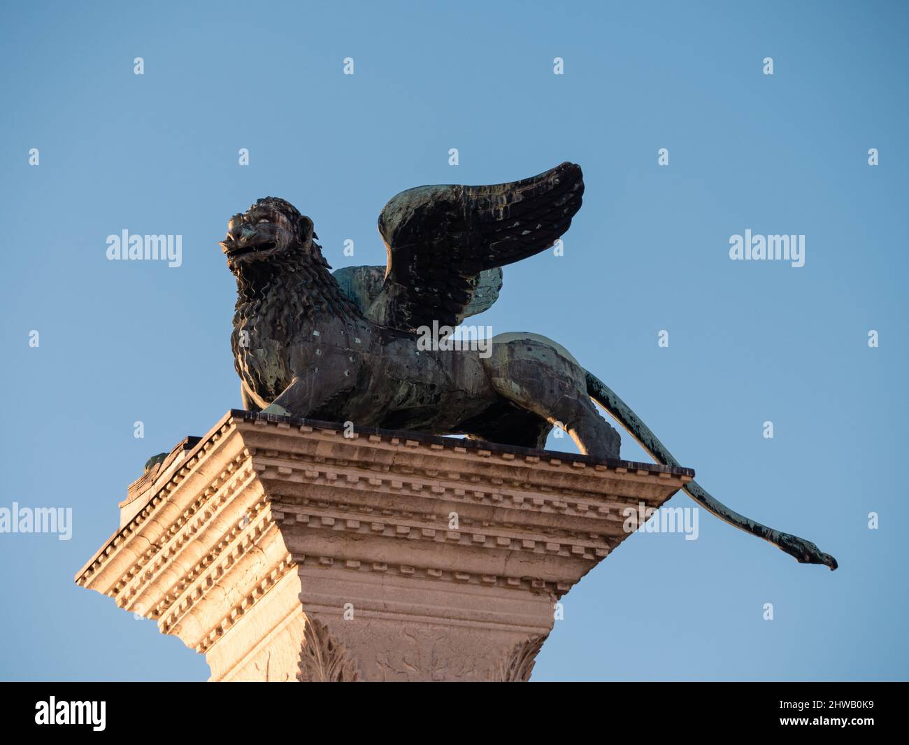 Lion of Venice Bronze Sculpture on the Column of Saint Mark on the Piazzetta San Marco Square in Venice, Italy Stock Photo