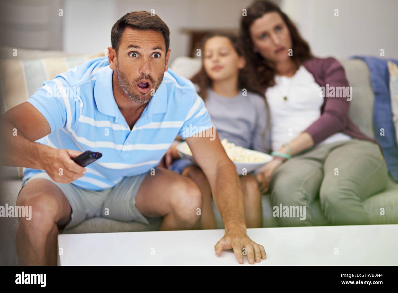 They dont know what theyre missing. Cropped shot of a family sitting on the sofa at home. Stock Photo