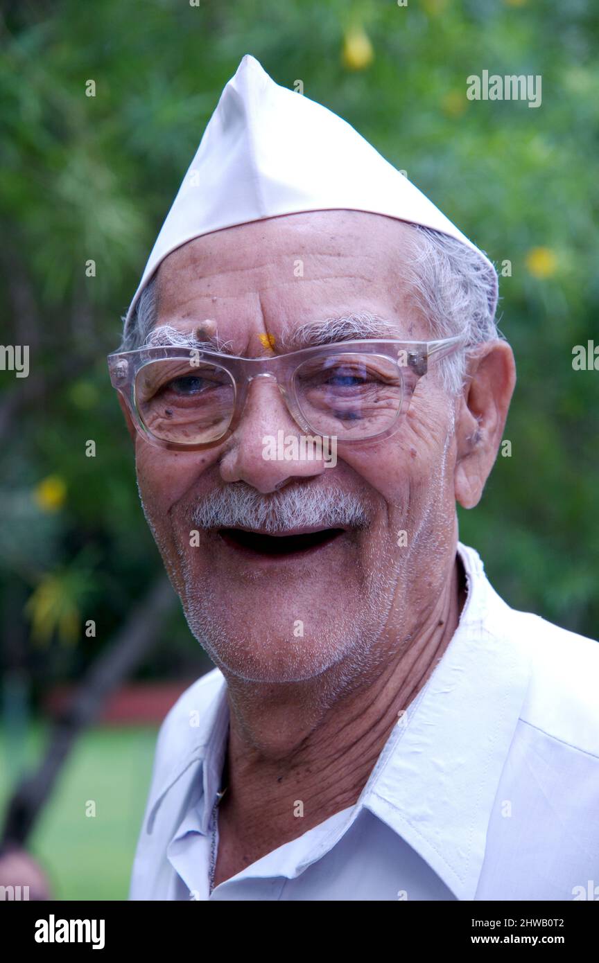 Mumbai, Maharashtra, India-  Sep. 08, 2011 Portrait of Indian wrinkled face Old Man wearing India's iconic Gandhi topi or Gandhi cap made from Khadi. Stock Photo
