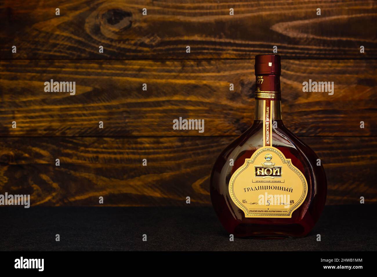 A bottle of Armenian brandy Noah Traditional 5 years of aging on a dark wooden background. Cognac introduces centuries-old traditions of Armenian bran Stock Photo