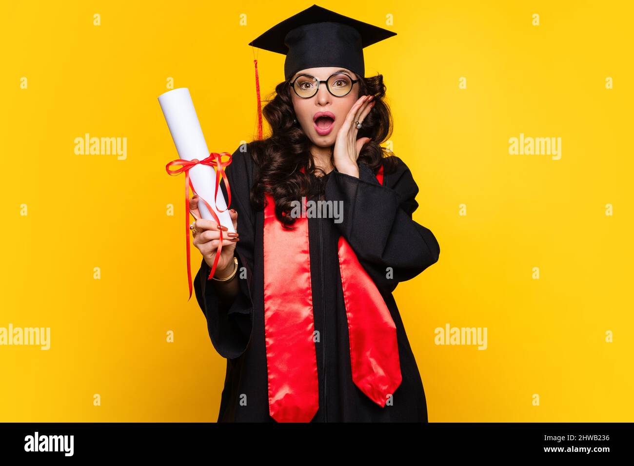 Shocked Girl graduate in graduation hat and eyewear with diploma on ...