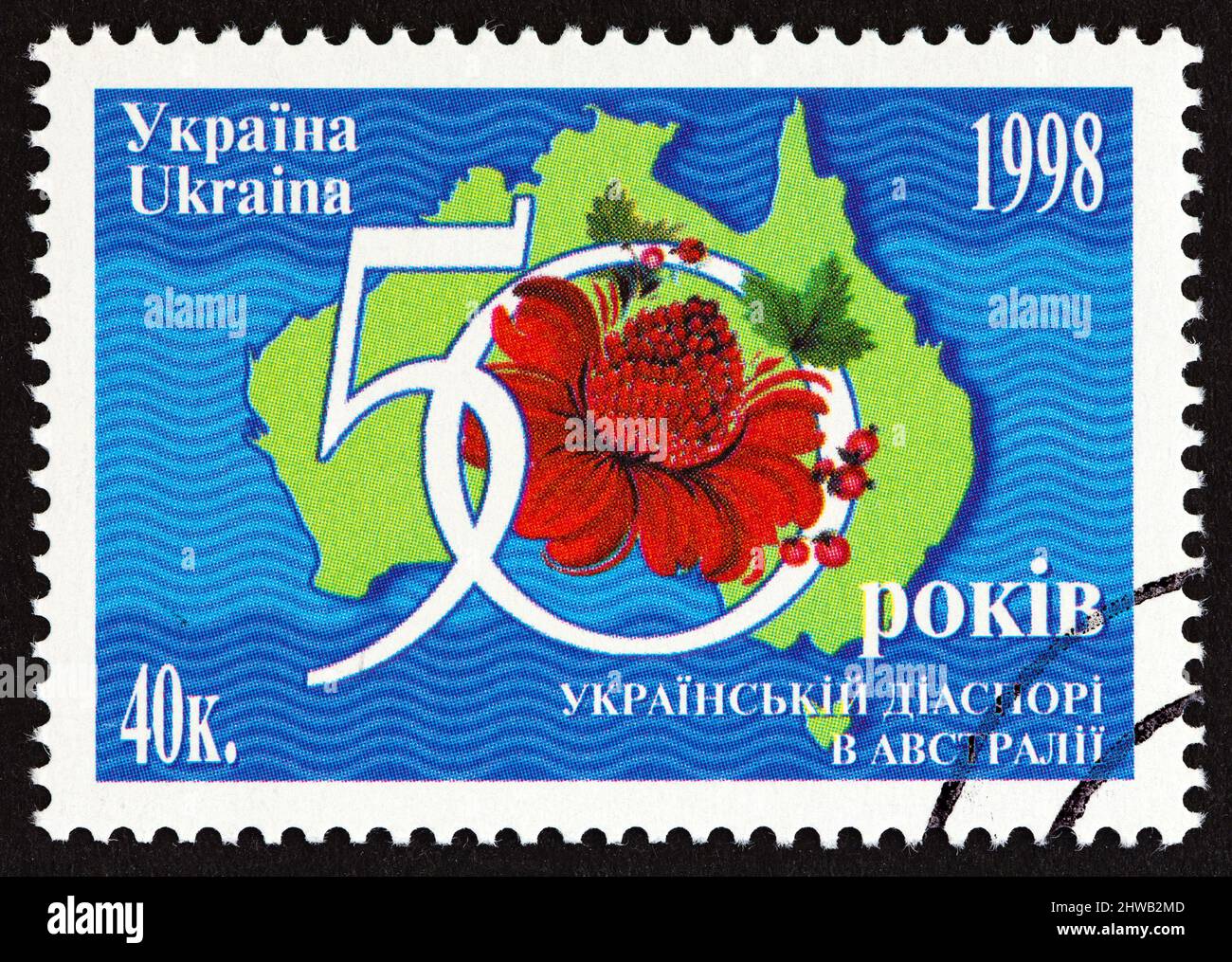 UKRAINE - CIRCA 1998: A stamp printed in Ukraine issued for the 50th anniversary of Ukrainians in Australia shows map of Australia and Waratah. Stock Photo