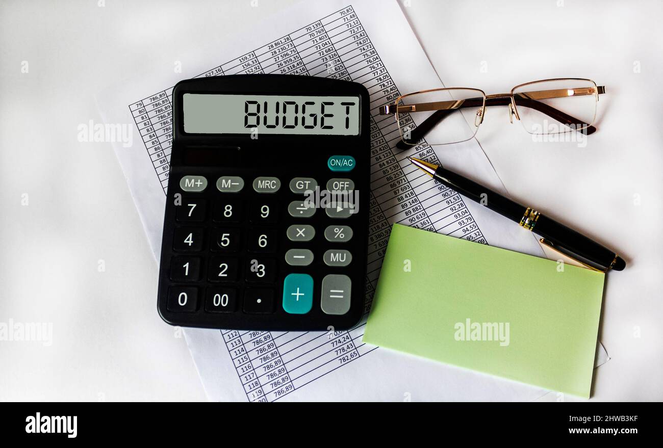 A pen that lies on a calculator on a background of dollars, close-up.  Concept of successful financial business. Side upper view Stock Photo -  Alamy