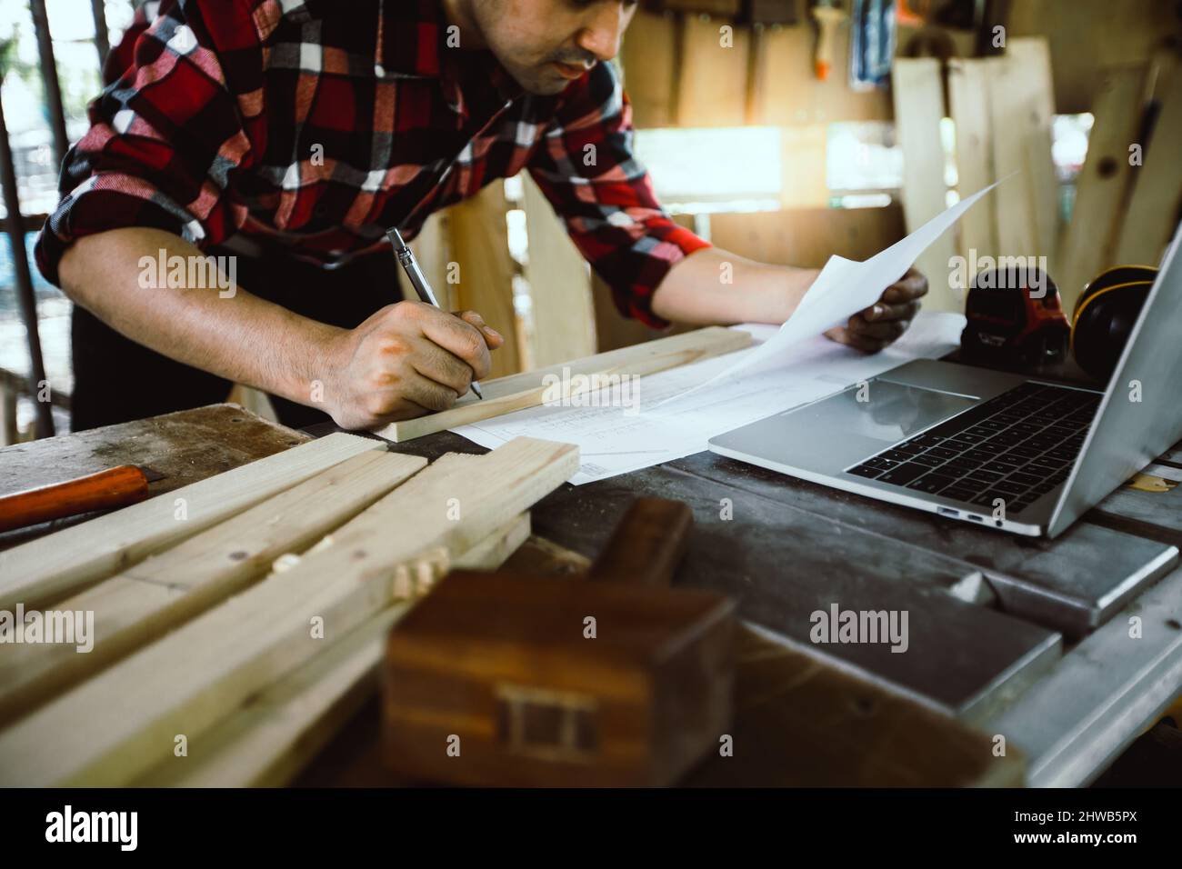 carpenter or architect looking on paper sketch working in site work Stock Photo