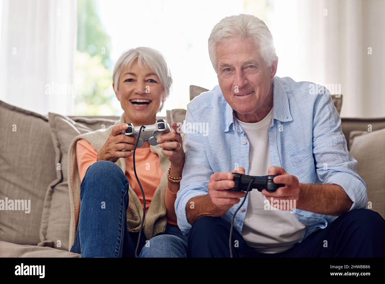 Competitive boyfriend and girlfriend playing video games funny Stock Photo