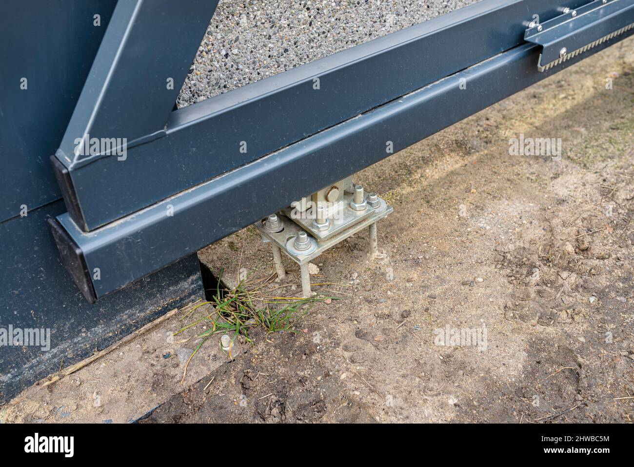 Modern sliding entrance gate in anthracite color, visible bolts