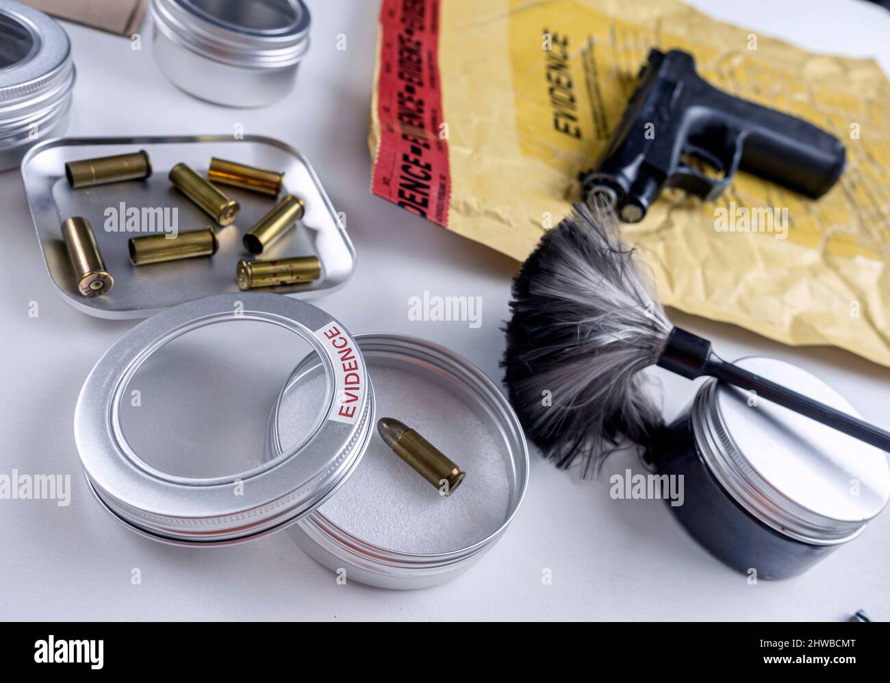 Bullet cap along with a gun in ballistic laboratory, conceptual image Stock Photo