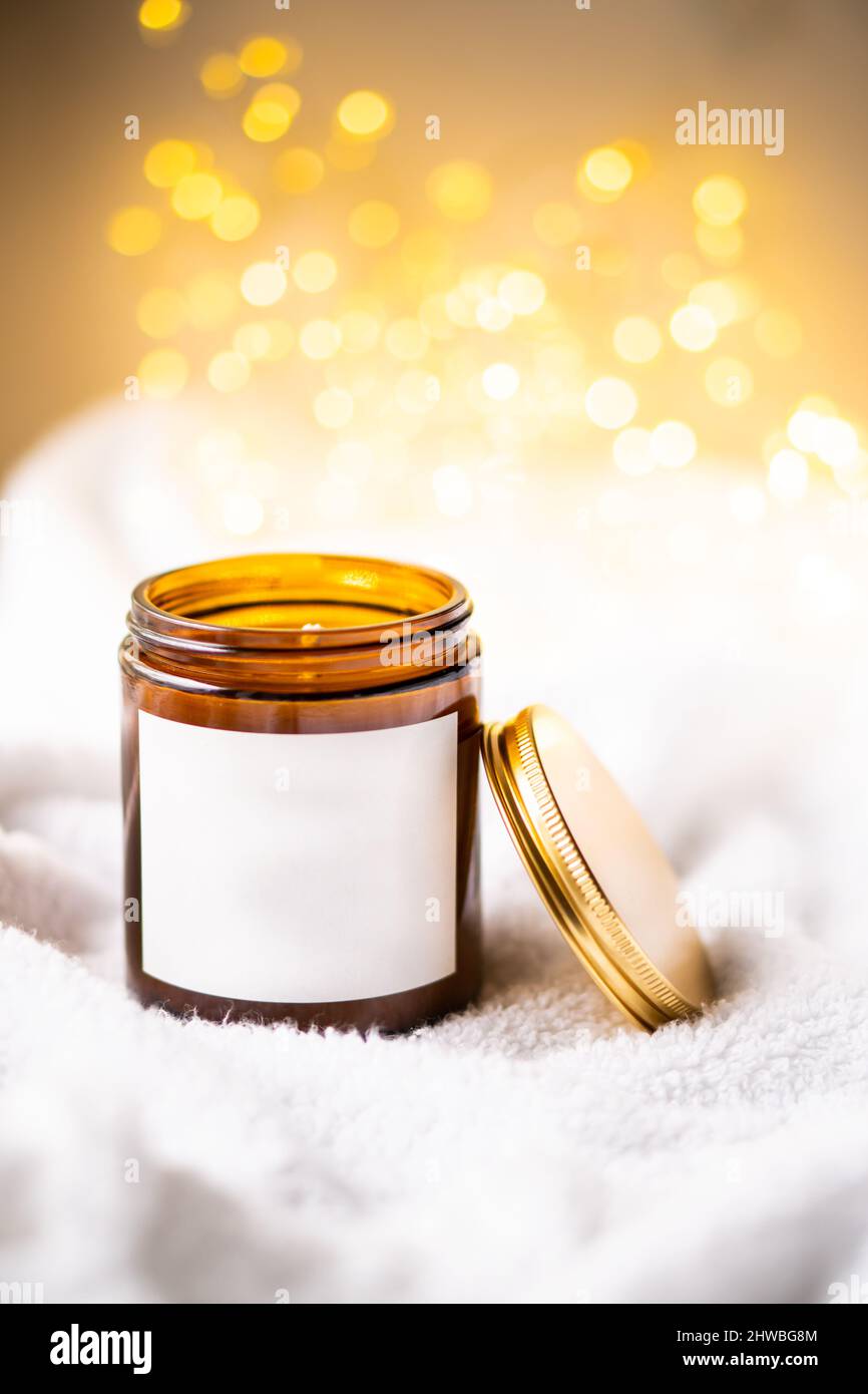 Natural wax candle in brown glass jar with metal lid and white empty ...