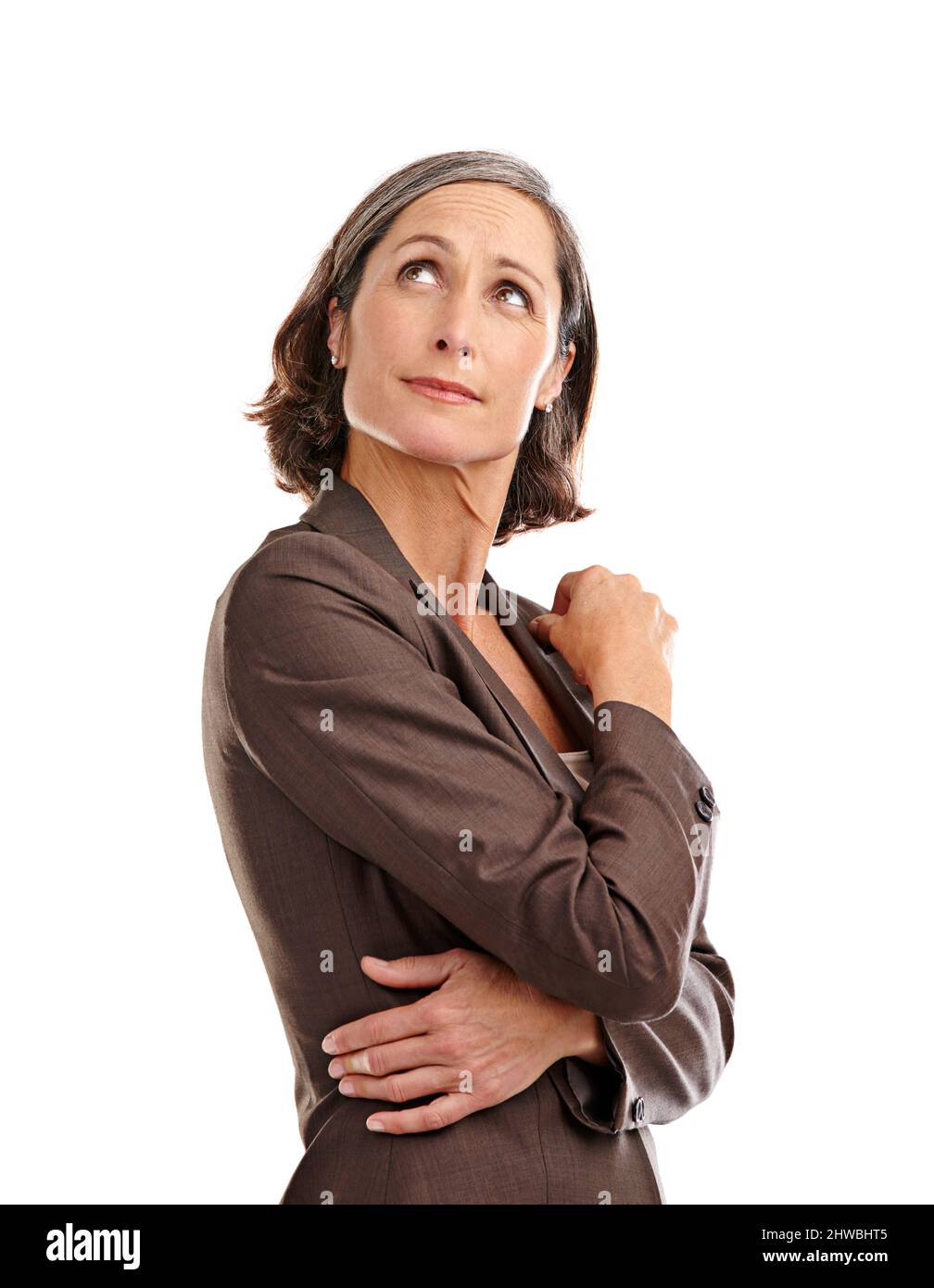 Something caught her attention there. Shot of an attractive mature woman in business attire looking up at copyspace. Stock Photo