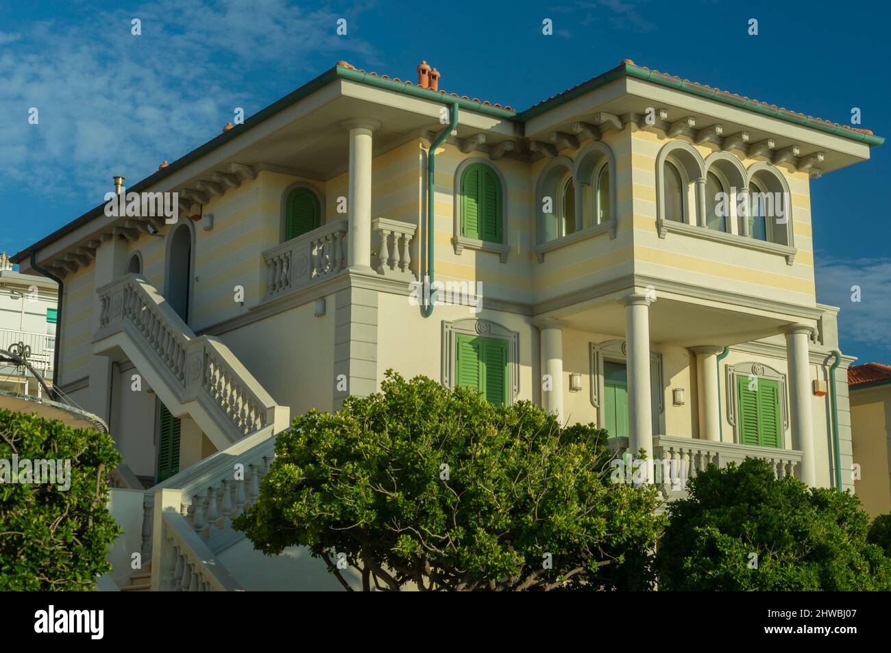 Beautiful Tuscan style seaside villa with columns, arches and green shutters Stock Photo