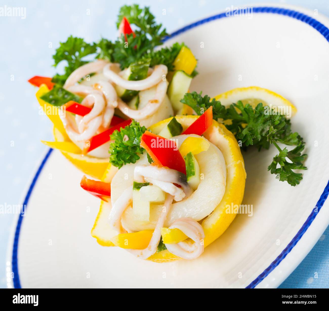 Delicious seafood and vegetables salad with squids, cucumbers, red pepper with olive oil and